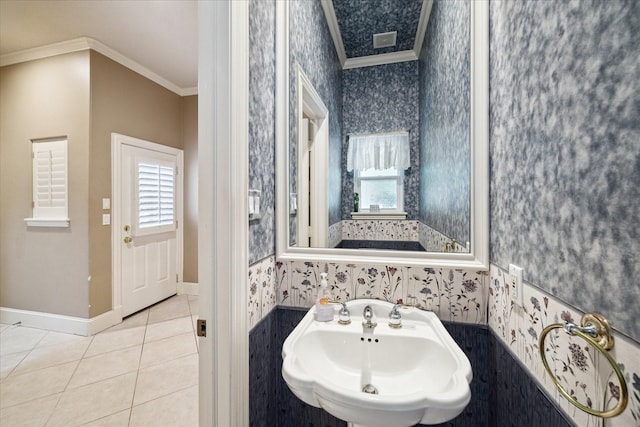 1615 Lake Wilderness Ln, Kingwood, TX 77345 - bathroom featuring wallpapered walls, crown molding, a sink, plenty of natural light, and tile patterned flooring