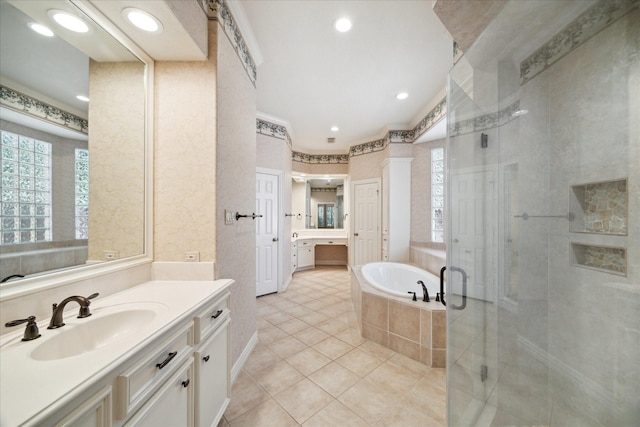 1615 Lake Wilderness Ln, Kingwood, TX 77345 - full bathroom with a shower stall, two vanities, tile patterned floors, a garden tub, and ornamental molding