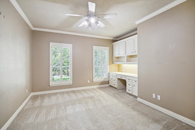 1615 Lake Wilderness Ln, Kingwood, TX 77345 - unfurnished office featuring built in desk, ceiling fan, light carpet, ornamental molding, and a textured ceiling