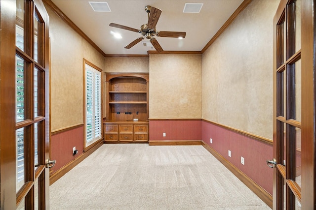 1615 Lake Wilderness Ln, Kingwood, TX 77345 - carpeted spare room featuring ornamental molding, a ceiling fan, and a wainscoted wall