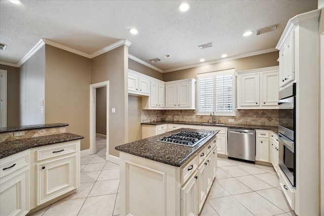 1615 Lake Wilderness Ln, Kingwood, TX 77345 - kitchen with stainless steel appliances, light tile patterned floors, backsplash, a textured ceiling, and a sink