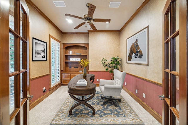 1615 Lake Wilderness Ln, Kingwood, TX 77345 - sitting room featuring crown molding, wainscoting, ceiling fan, carpet, and baseboards