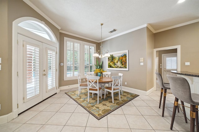 1615 Lake Wilderness Ln, Kingwood, TX 77345 - dining space featuring baseboards, crown molding, light tile patterned flooring, a chandelier, and a textured ceiling