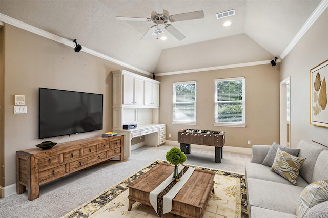 1615 Lake Wilderness Ln, Kingwood, TX 77345 - living room featuring a ceiling fan, ornamental molding, light colored carpet, vaulted ceiling, and baseboards