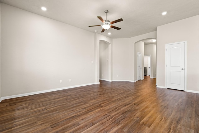 14370 S Summerchase Cir, Willis, TX 77318 - empty room featuring a ceiling fan, arched walkways, dark wood-style flooring, recessed lighting, and baseboards