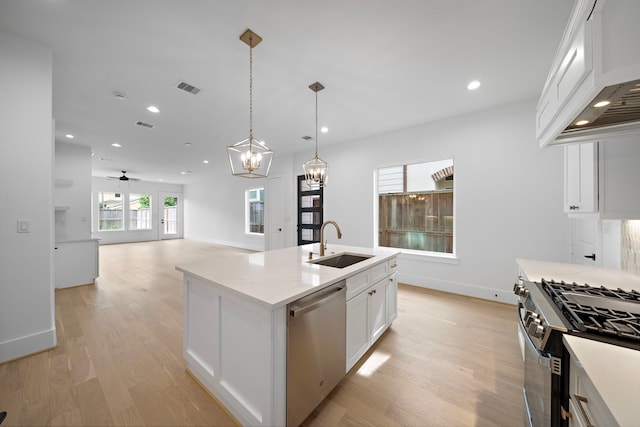 224 W 23rd St Unit B, Houston, TX 77008 - kitchen with appliances with stainless steel finishes, a sink, custom range hood, light wood-style flooring, and recessed lighting