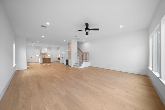 224 W 23rd St Unit B, Houston, TX 77008 - unfurnished living room featuring stairway, light wood-style floors, ceiling fan, baseboards, and recessed lighting