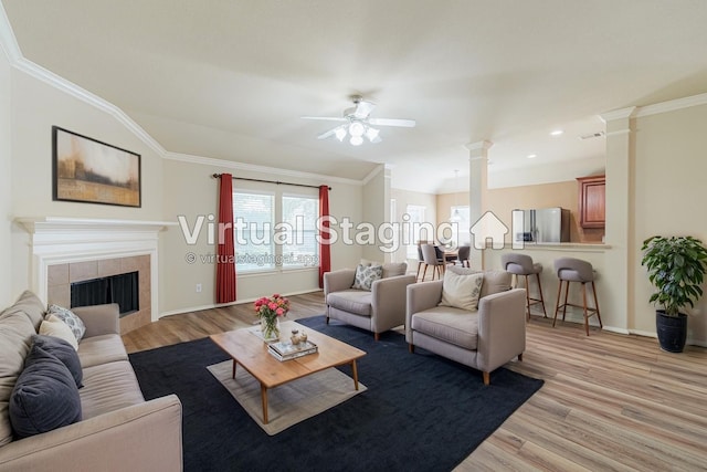 8714 Ridgebury Cir, Houston, TX 77095 - living area featuring healthy amount of natural light, light wood finished floors, decorative columns, ornamental molding, and recessed lighting