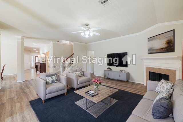 8714 Ridgebury Cir, Houston, TX 77095 - living area featuring light wood-type flooring, stairway, a tile fireplace, ceiling fan, and baseboards