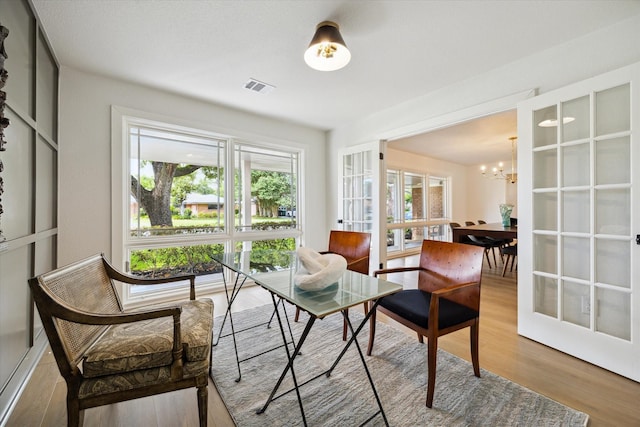 4601 Creekbend Dr, Houston, TX 77035 - sitting room with light wood-style flooring, a chandelier, and french doors