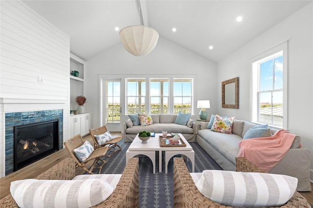 2604 E Seaside Dr, Galveston, TX 77550 - living room with wood finished floors, healthy amount of natural light, recessed lighting, high vaulted ceiling, and a premium fireplace