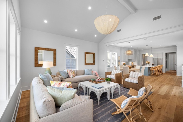 2604 E Seaside Dr, Galveston, TX 77550 - living area featuring light wood-style flooring, beamed ceiling, recessed lighting, high vaulted ceiling, and baseboards
