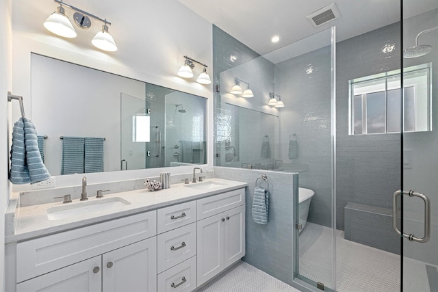 2604 E Seaside Dr, Galveston, TX 77550 - bathroom featuring a stall shower, double vanity, a soaking tub, and tile patterned flooring