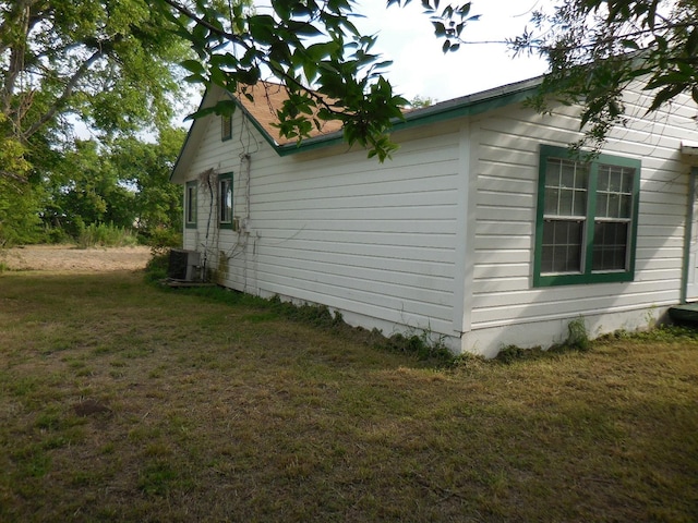 628 Austin St W, Matagorda, TX 77457 - view of side of property with a lawn and central AC unit