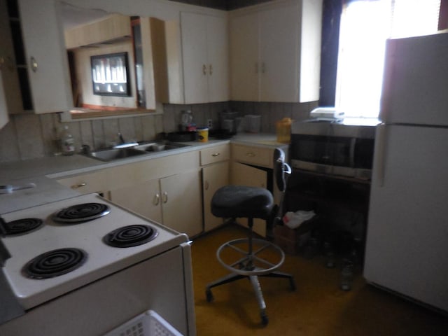 628 Austin St W, Matagorda, TX 77457 - kitchen featuring white appliances, a sink, light countertops, and white cabinetry