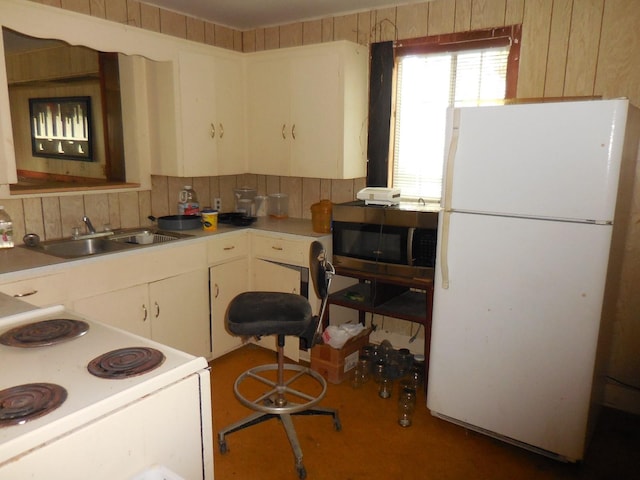 628 Austin St W, Matagorda, TX 77457 - kitchen featuring white appliances, a sink, white cabinetry, and light countertops