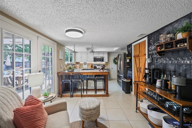 23910 Spring Day Ln, Spring, TX 77373 - living room with light tile patterned floors and a textured ceiling