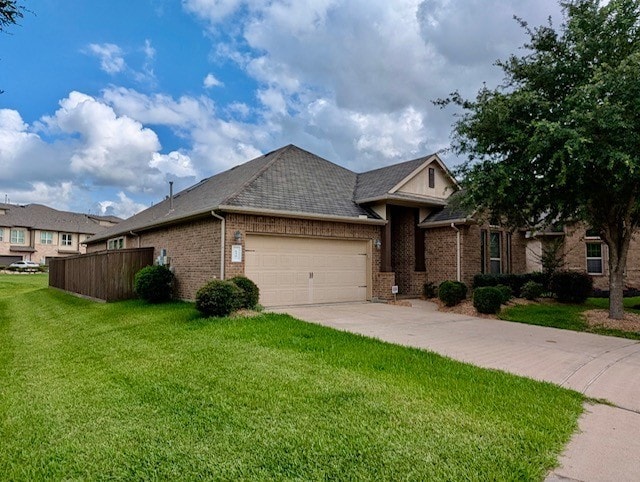 634 Pedernales St, Webster, TX 77598 - view of front of house featuring an attached garage, driveway, and brick siding