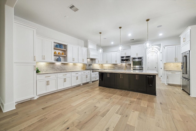 19 Sanctuary Trl, Missouri City, TX 77459 - kitchen featuring appliances with stainless steel finishes, white cabinets, light wood-style floors, backsplash, and recessed lighting