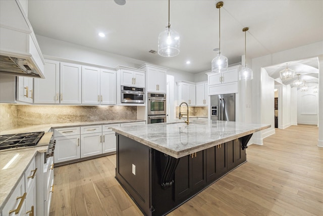 19 Sanctuary Trl, Missouri City, TX 77459 - kitchen with appliances with stainless steel finishes, custom exhaust hood, white cabinets, backsplash, and light wood-type flooring