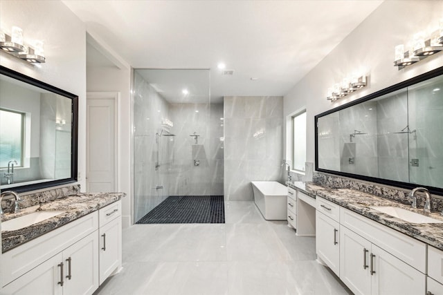 19 Sanctuary Trl, Missouri City, TX 77459 - bathroom featuring a shower stall, two vanities, and a soaking tub