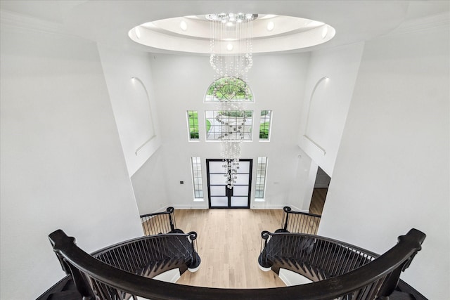 19 Sanctuary Trl, Missouri City, TX 77459 - entryway with a high ceiling, wood finished floors, a raised ceiling, french doors, and a chandelier