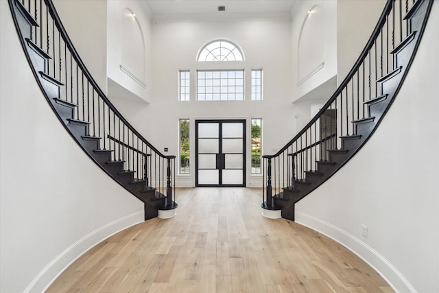 19 Sanctuary Trl, Missouri City, TX 77459 - foyer entrance featuring stairway, wood finished floors, a towering ceiling, and crown molding