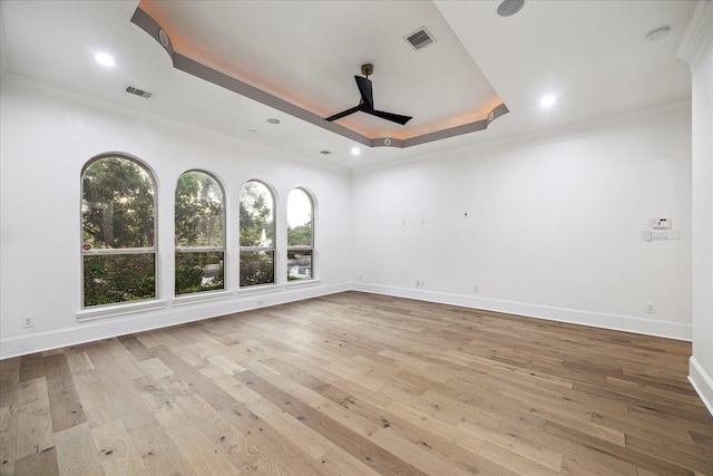 19 Sanctuary Trl, Missouri City, TX 77459 - empty room featuring a tray ceiling, plenty of natural light, ornamental molding, wood-type flooring, and recessed lighting