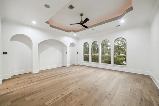 19 Sanctuary Trl, Missouri City, TX 77459 - spare room with a ceiling fan, a raised ceiling, crown molding, light wood finished floors, and recessed lighting