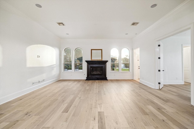19 Sanctuary Trl, Missouri City, TX 77459 - unfurnished living room with light wood-style floors, crown molding, and a glass covered fireplace