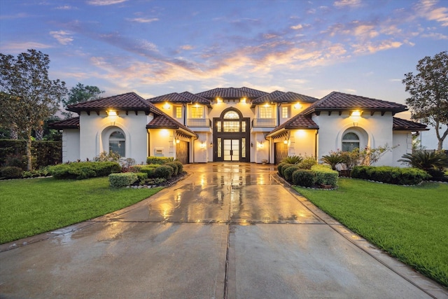 19 Sanctuary Trl, Missouri City, TX 77459 - mediterranean / spanish house with stucco siding, a tiled roof, concrete driveway, a garage, and a front lawn