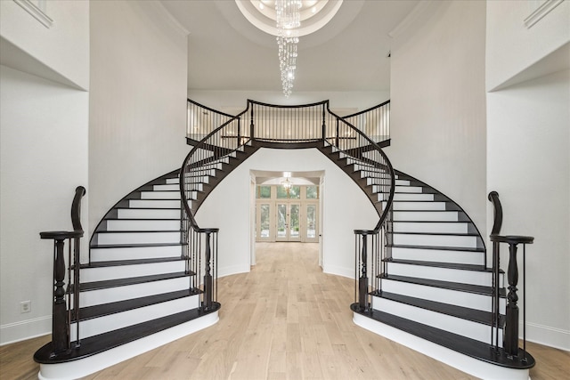 19 Sanctuary Trl, Missouri City, TX 77459 - stairway featuring a chandelier, wood finished floors, and french doors