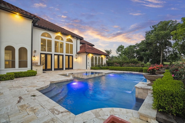 19 Sanctuary Trl, Missouri City, TX 77459 - pool at dusk with a patio area and a pool with connected hot tub