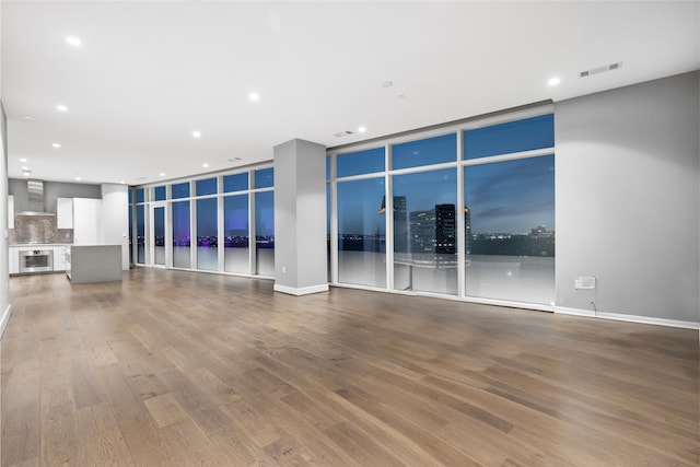 4521 San Felipe St Unit 2601, Houston, TX 77027 - unfurnished living room with wood finished floors, recessed lighting, and wine cooler