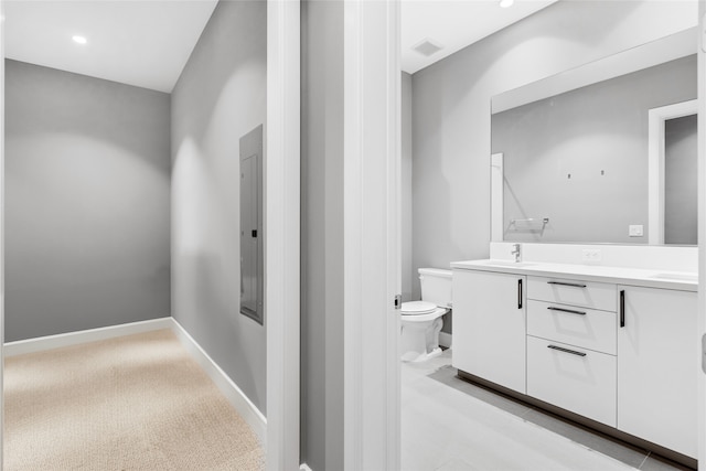 4521 San Felipe St Unit 2601, Houston, TX 77027 - bathroom featuring toilet, double vanity, electric panel, recessed lighting, and baseboards