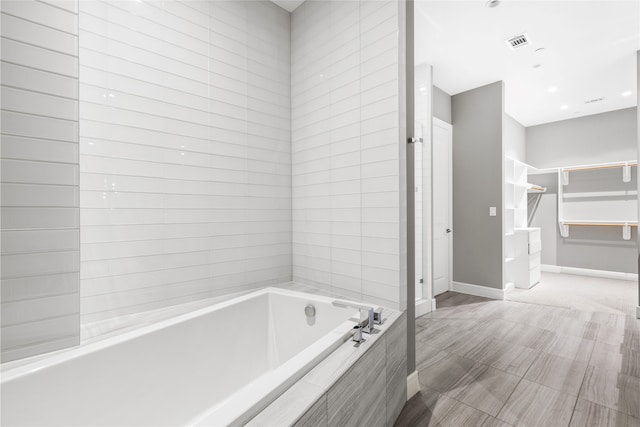 4521 San Felipe St Unit 2601, Houston, TX 77027 - full bathroom with a garden tub and baseboards