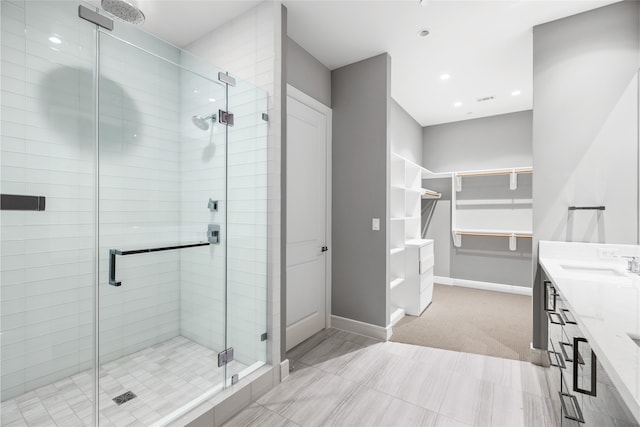 4521 San Felipe St Unit 2601, Houston, TX 77027 - full bathroom with a shower stall, double vanity, a walk in closet, baseboards, and recessed lighting
