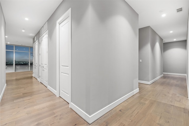 4521 San Felipe St Unit 2601, Houston, TX 77027 - corridor featuring light wood-style flooring, baseboards, and recessed lighting