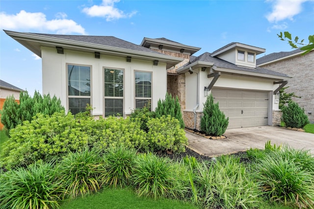29510 Enchanted Breeze Ln, Katy, TX 77494 - prairie-style home with stucco siding, concrete driveway, stone siding, roof with shingles, and an attached garage