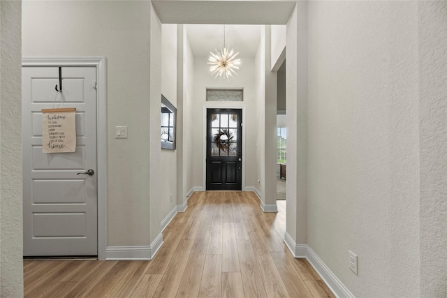 29510 Enchanted Breeze Ln, Katy, TX 77494 - entrance foyer with light wood finished floors, a chandelier, baseboards, and a textured wall