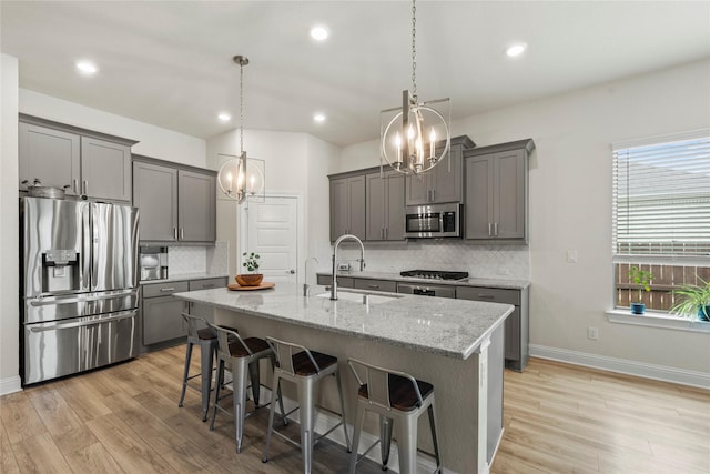 29510 Enchanted Breeze Ln, Katy, TX 77494 - kitchen with appliances with stainless steel finishes, a chandelier, a sink, gray cabinets, and recessed lighting