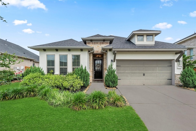 29510 Enchanted Breeze Ln, Katy, TX 77494 - view of front facade with concrete driveway, an attached garage, stone siding, and stucco siding