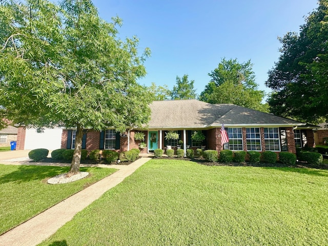 1308 Hagan St, Crockett, TX 75835 - ranch-style home with a front lawn, brick siding, and a shingled roof
