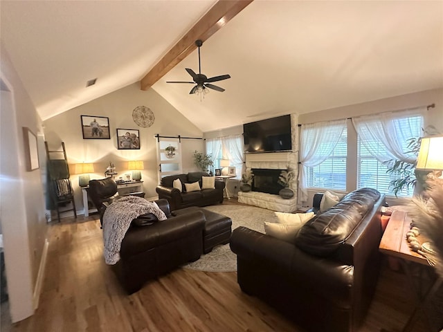 1308 Hagan St, Crockett, TX 75835 - living room featuring wood finished floors, ceiling fan, and a stone fireplace