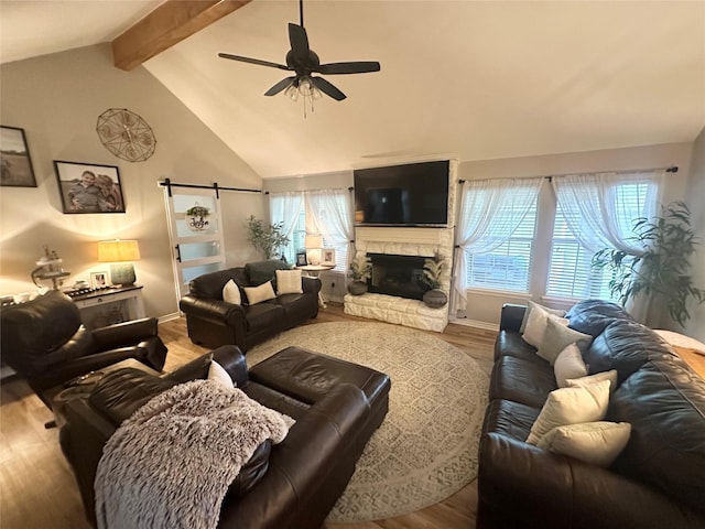 1308 Hagan St, Crockett, TX 75835 - living area with wood finished floors, healthy amount of natural light, ceiling fan, and a fireplace
