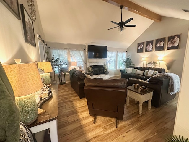 1308 Hagan St, Crockett, TX 75835 - living room with a ceiling fan, beam ceiling, wood finished floors, a glass covered fireplace, and high vaulted ceiling