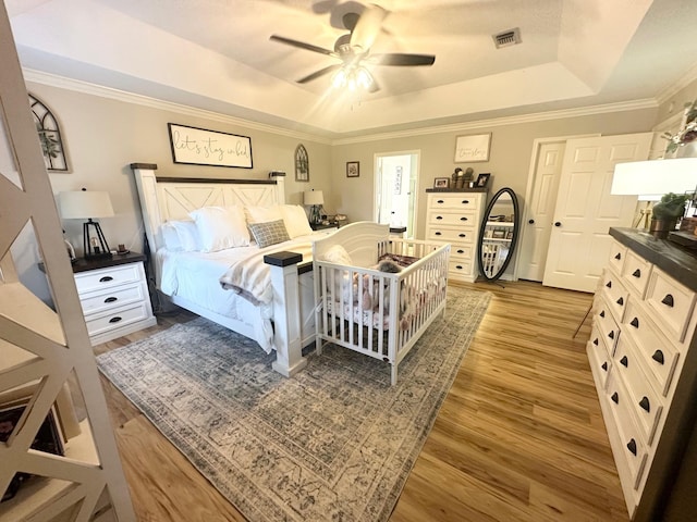 1308 Hagan St, Crockett, TX 75835 - bedroom with a raised ceiling, wood finished floors, ornamental molding, and ceiling fan
