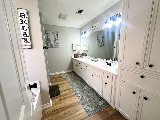 1308 Hagan St, Crockett, TX 75835 - full bath with double vanity, baseboards, and wood finished floors