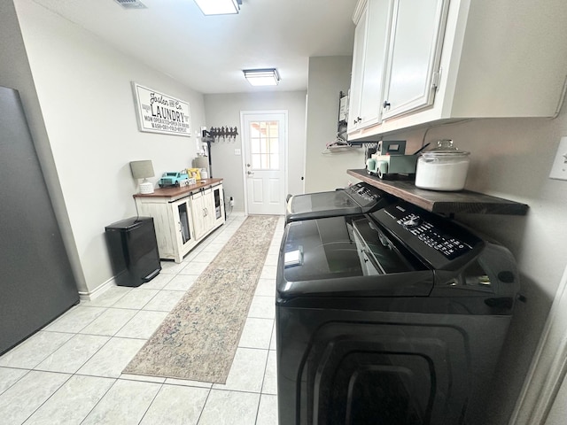 1308 Hagan St, Crockett, TX 75835 - kitchen with washer and dryer, light tile patterned floors, white cabinetry, and baseboards