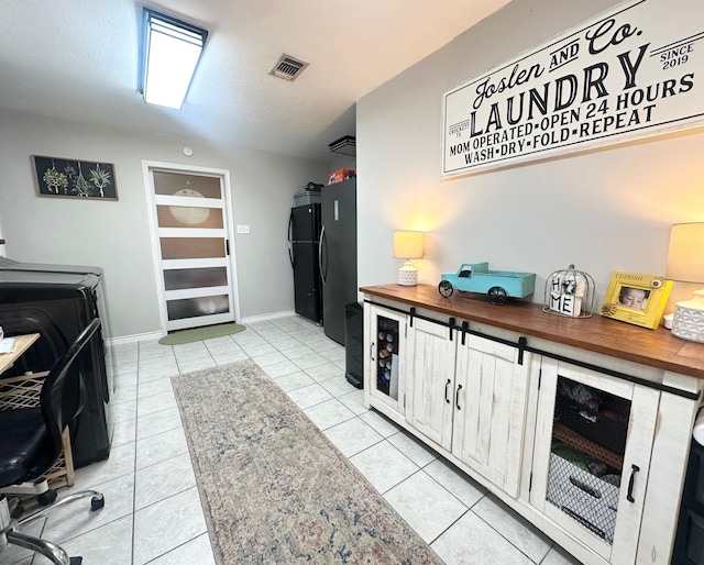 1308 Hagan St, Crockett, TX 75835 - laundry room featuring separate washer and dryer, light tile patterned flooring, and baseboards